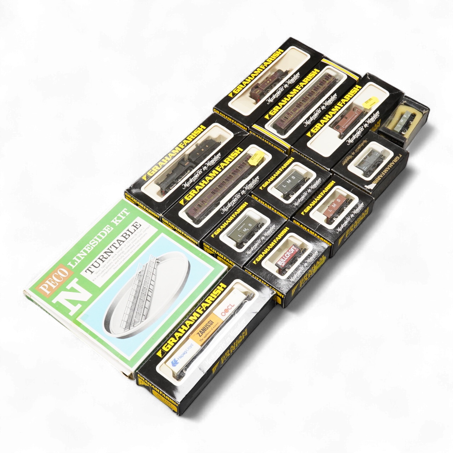 Thirteen N gauge railway by Graham Farish, etc., including two locomotives; a BR Class 4 0-6-0 tender locomotive, 4232, and an LMS 0-6-0T locomotive, 16389, together with two bogie coaches, eight freight wagons, and a Pe